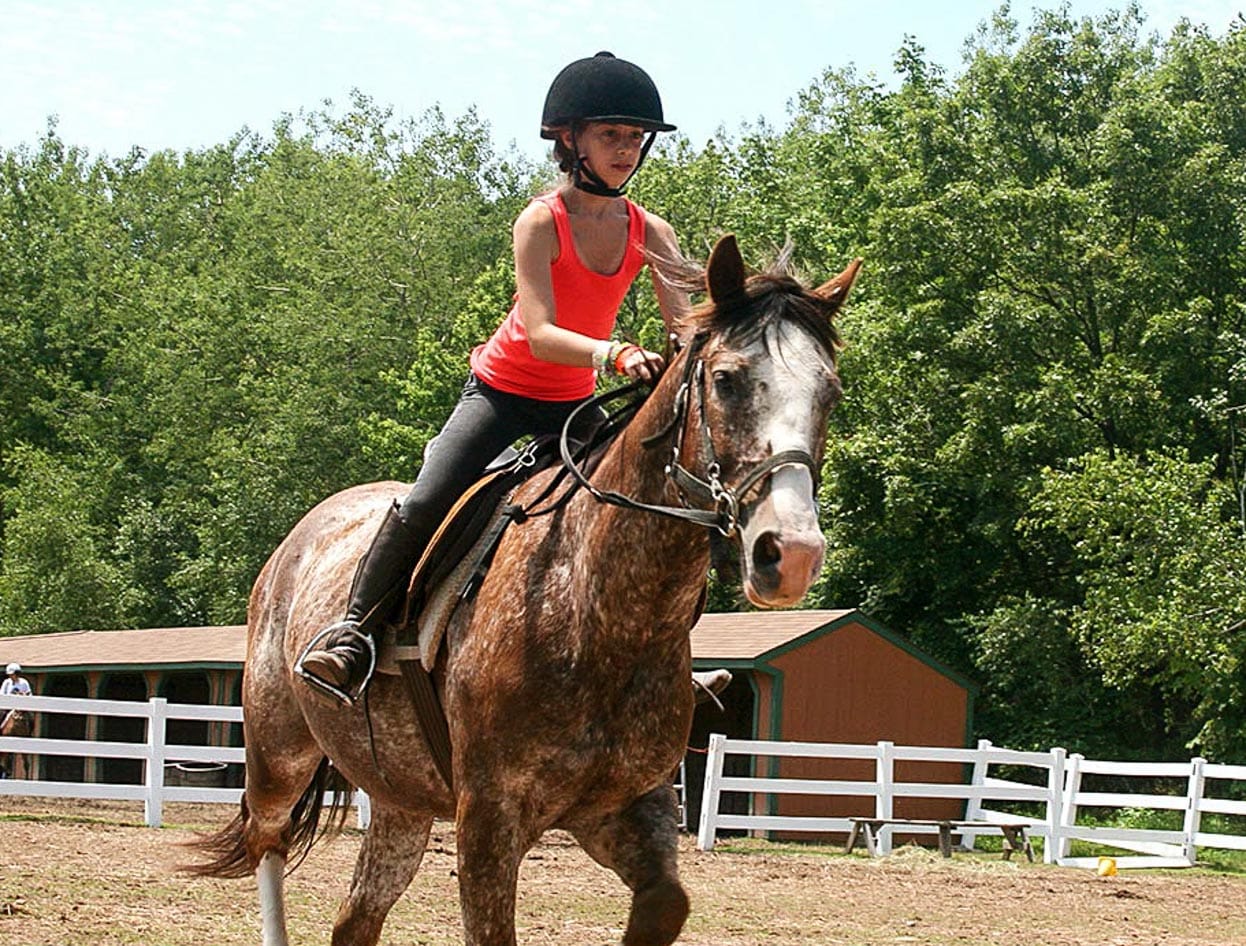 girl camper horseback riding