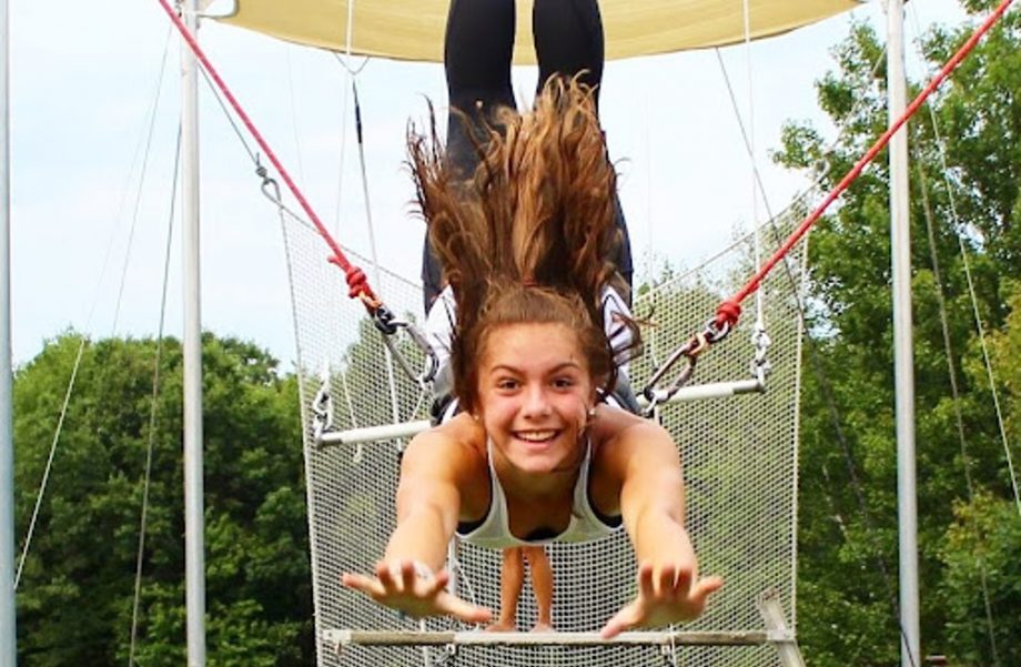 a girl mid-air on trapeze.