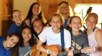 Campers learning to play guitar