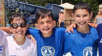 Boys at a waterpark smiling.